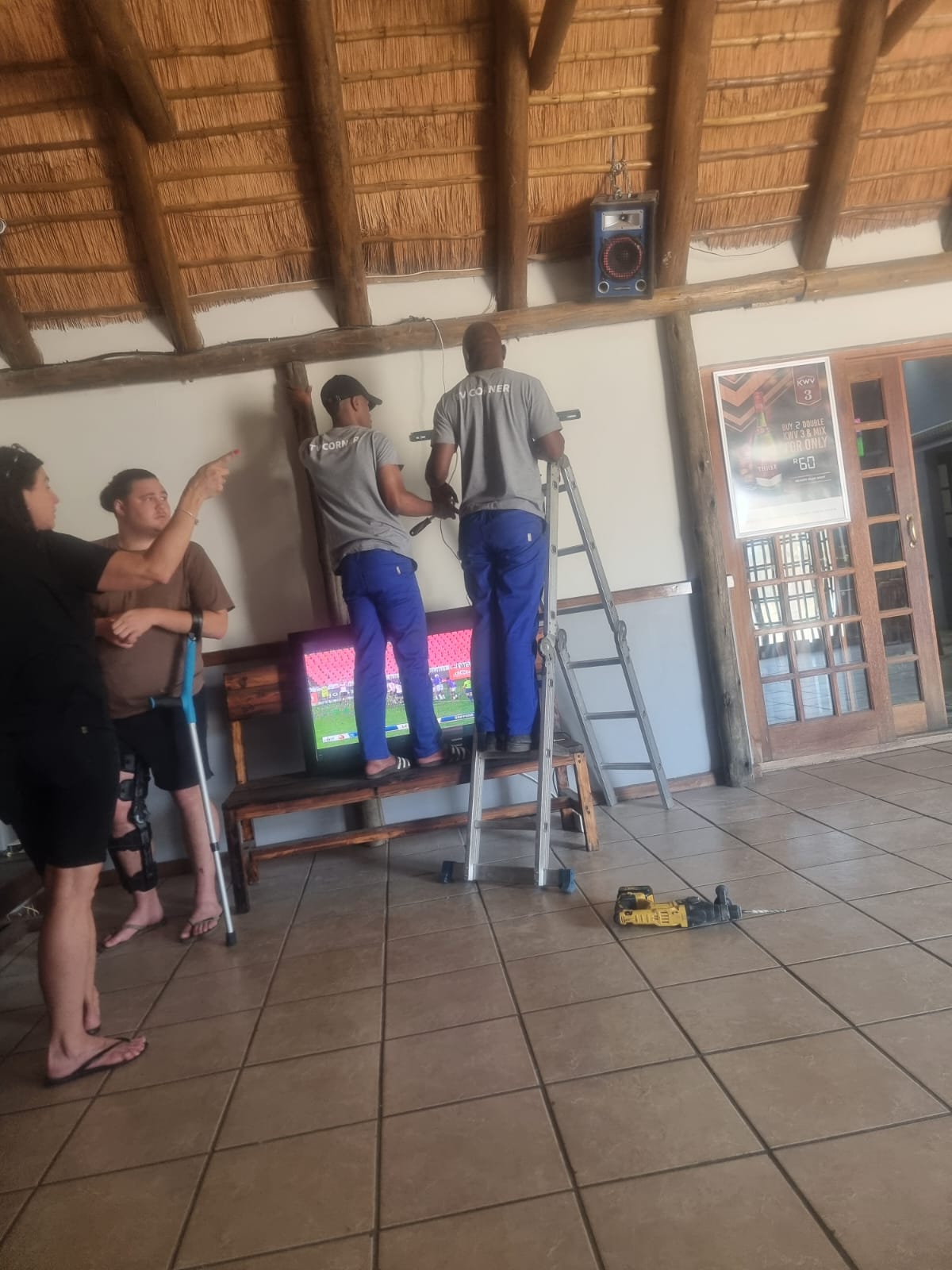 TV Corner team installing a wall-mounted TV